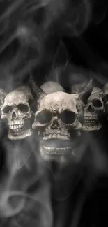 A dark wallpaper with skulls and swirling smoke.