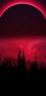 Crimson eclipse with silhouetted trees in a night scene.