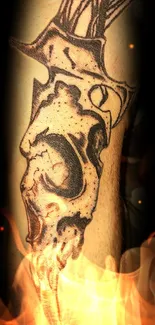 Tattoo skull with flames on dark themed wallpaper.