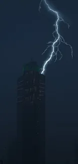 Lightning striking a dark skyscraper at night.