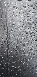 Close-up of water droplets on a sleek gray surface, perfect for a modern wallpaper.