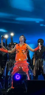 Energetic concert scene with blue lights and performers on stage.