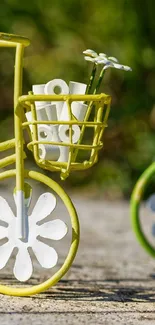 Artistic miniature bicycles with a nature backdrop.