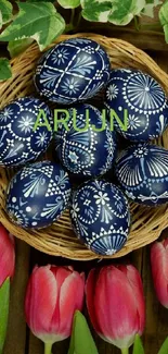 Blue Easter eggs in a basket with pink tulips and greenery.