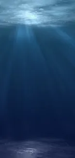 Serene underwater scene with deep blue hues and gentle light rays.
