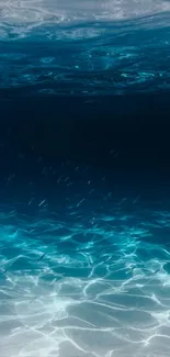 Underwater view with deep blue colors and light patterns in the ocean.