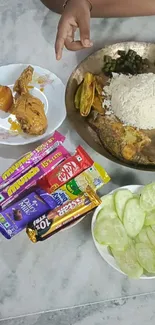 Plate of Indian meal with rice, curry, and snacks.