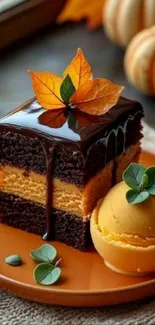 Chocolate cake with autumn leaves and ice cream sits on a plate.