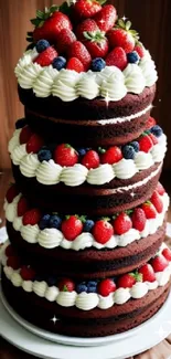 Tall berry chocolate cake with strawberries and cream layers.