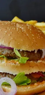 Juicy burger with lettuce and side of fries on mobile wallpaper.