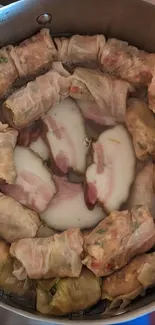 Overhead view of cabbage rolls in a pot.