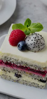 Cake with berries, dragon fruit, and mint leaves on top.