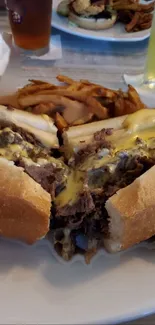 Close-up of a cheesesteak sandwich with fries.