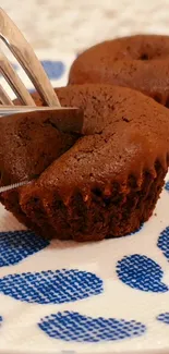 Chocolate cupcakes on a decorative plate.