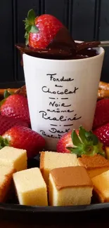Chocolate fondue tray with strawberries, cake cubes, and pretzels.