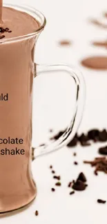 Chocolate milkshake with scattered chocolate pieces on a light background.