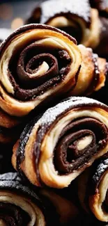 Close-up of chocolate pastry rolls piled up high.