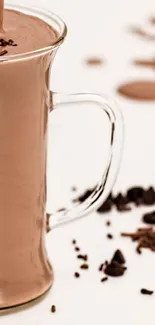 Brown chocolate shake in glass with chocolate pieces.