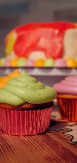 Colorful cupcakes with vibrant frosting displayed on a wooden surface.