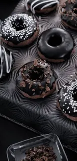 Dark chocolate donuts arranged elegantly with ornate decorations.