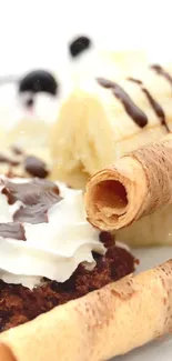 Close-up of delicious dessert with bananas, cream, and wafer rolls on a white plate.