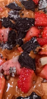 Close-up of chocolate, strawberries, and cookie crumble dessert.