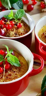 Colorful dessert cups with fresh berries and mint leaves.