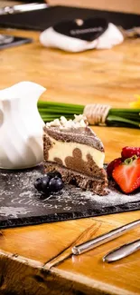 Chocolate cake with strawberries and blueberries on slate.