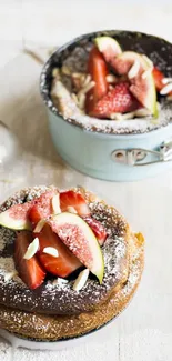 Freshly baked cakes with strawberries and figs on a light wooden board.