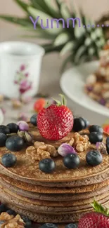 Stack of pancakes with strawberries and blueberries.