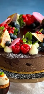 Chocolate cake with berries and floral decor on a blue backdrop.
