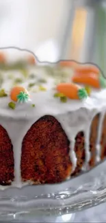 Close-up of a beautifully decorated carrot cake with icing and colorful toppings.