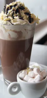 Hot chocolate with whipped cream and marshmallows in a cozy setting.