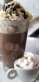 Tall glass of hot chocolate with whipped cream and marshmallows on plate.
