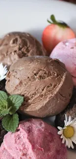Scoops of chocolate and berry ice cream with strawberries and daisies.