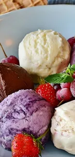 Colorful ice cream scoops with berries in a bowl.