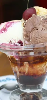 Ice cream sundae with cherry on top on a wooden table.