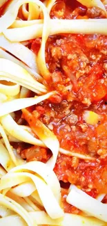 Close-up of pasta with rich tomato sauce on a mobile wallpaper.