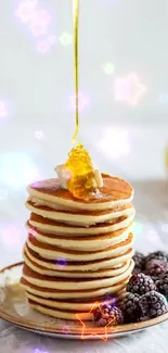 Stack of pancakes with honey drizzle and blackberries.