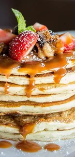 Pancake stack with caramel and strawberries.