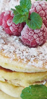 Stack of pancakes with raspberries and mint.