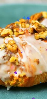 Pastry with icing and nuts on turquoise plate wallpaper.