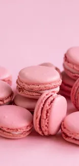 Pile of pink macarons on a pastel background.