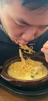 Man enjoying a bowl of delicious ramen noodles.