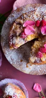 Top view of a raspberry cake with pink petals and icing sugar.