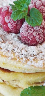 Stack of pancakes topped with raspberries and mint.