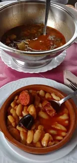 Spanish bean stew with chorizo served in a rustic bowl.