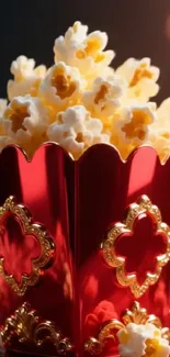 Lavish red and gold popcorn box filled with popcorn.