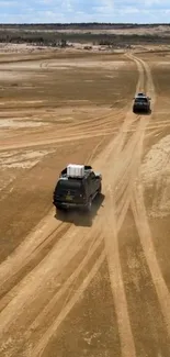 4x4 vehicles on a sandy desert trail, capturing an adventurous off-road journey.