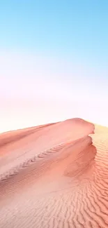 Serene desert dunes at sunset with pink and blue sky.